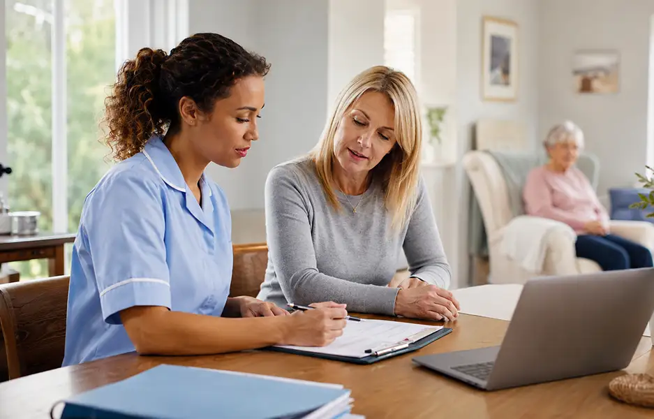 two women chatting over important documents
